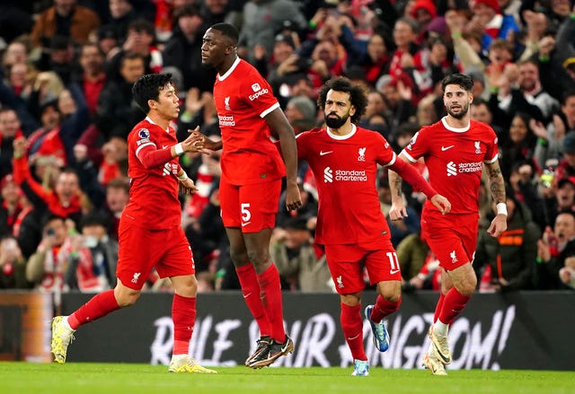 Liverpool’s Mo Salah, second right, celebrates his equaliser at Anfield against Arsenal, who retained top spot in the table for Christmas 