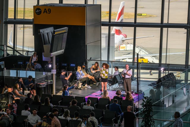 RnB artist Olivia Nelson performing to passengers in the first of a series of surprise gigs at the Heathrow Introducing stage at Heathrow Airport Terminal 5