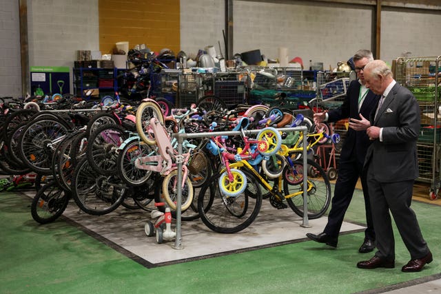 The King views donated and salvaged bikes awaiting refurbishment at the Renew Hub in Trafford Park, Manchester