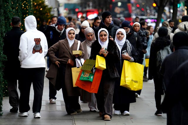 Women wearing hajibs and carrying shopping bags