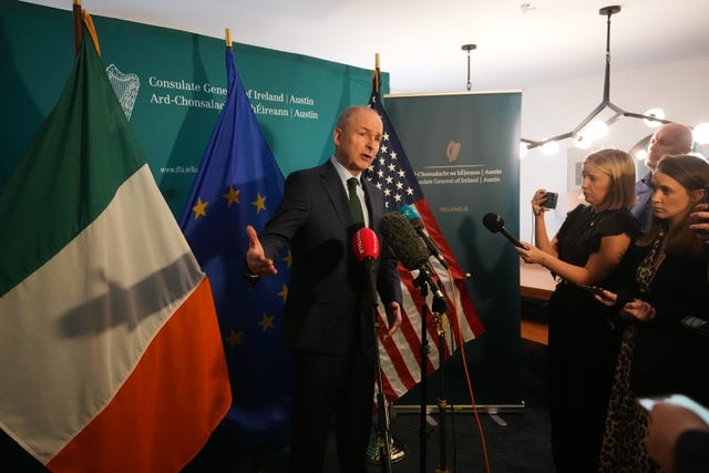 Micheal Martin speaking to the media in front of Irish and US flags