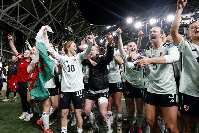 Roberts celebrates with her team-mates after the historic qualification was sealed (Damian Egers/PA)