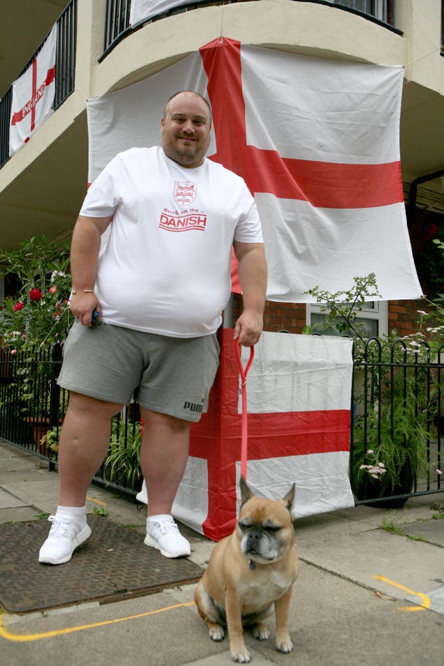 Chris Dowse and his eight-year-old French bulldog Tinkerbell on the Kirby Estate in Bermondsey where residents are showing their support for England