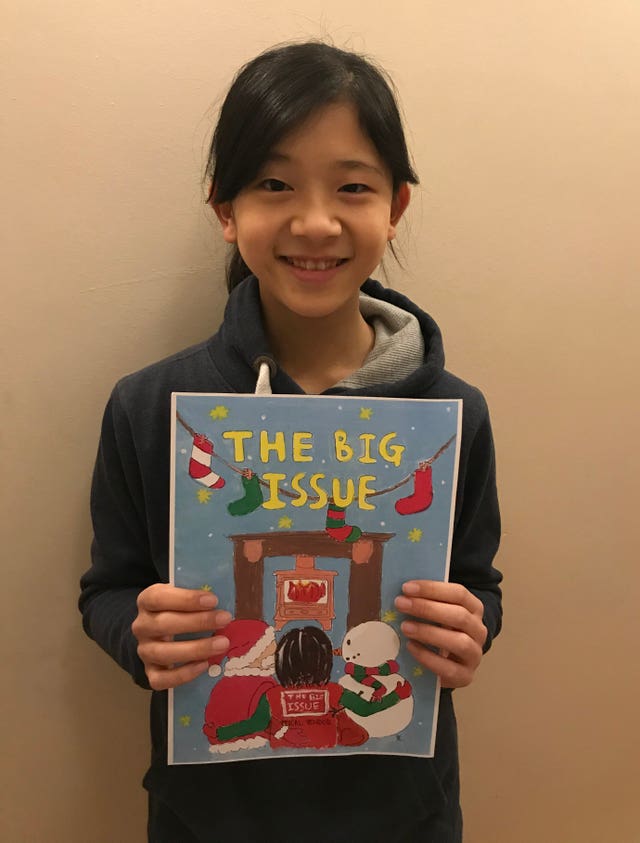 Twelve-year-old Kaoriko Tamura with her painting of a Big Issue seller next to Father Christmas and a snowman