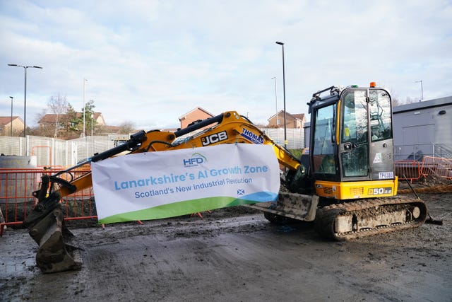 A view of a digger, which has a sign on it reading 'Lanarkshire's AI Growth Zone'