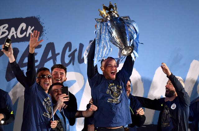 Kompany holds aloft the Premier League trophy