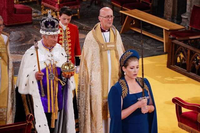 Penny Mordaunt walking ahead of the King 