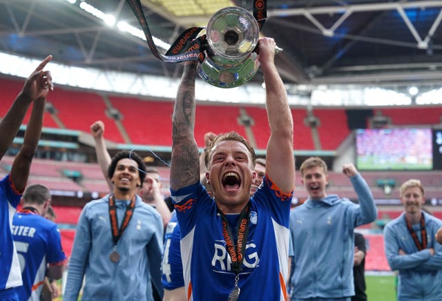 Tom Conlon lifts the trophy following the National League play-off final at Wembley