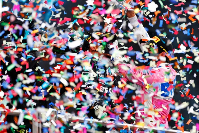 British driver Lewis Hamilton celebrates among ticker tape after making history by winning a dramatic Turkish Grand Prix to be crowned champion of the world for a record-equalling seventh time. The 35-year-old delivered arguably his finest display of the season to claim his 10th win from 14 races and match Michael Schumacher's all-time title haul with three rounds to spare. Hamilton was running in fifth for much of an eventful race but used all of his experience to make his intermediate tyres last for 50 of the 58 laps and take the chequered flag a staggering 31.6 seconds clear of Sergio Perez.