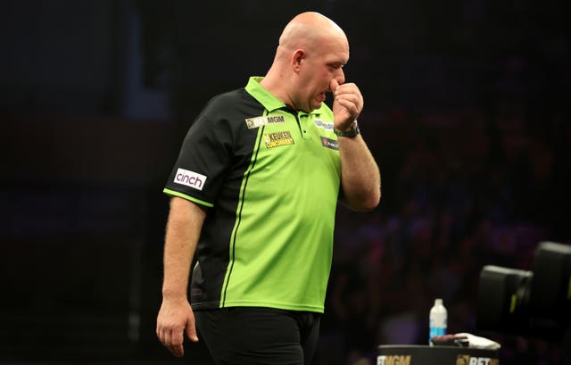 Michael van Gerwen looks disappointed on stage