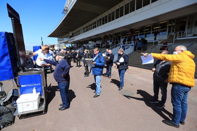 Racegoers place a bet at Redcar Racecourse 