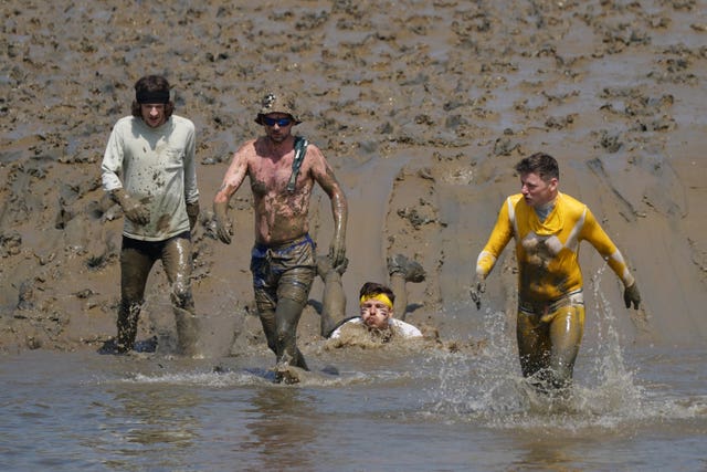 Competitors take part in the annual Maldon Mud Race, a charity event to race across the bed of the River Blackwater in Maldon, Essex 