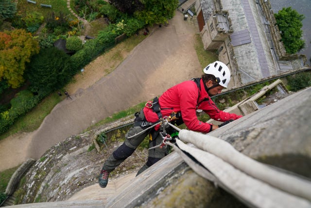 A worker seen from above cleaning a wall at Warwick Castle