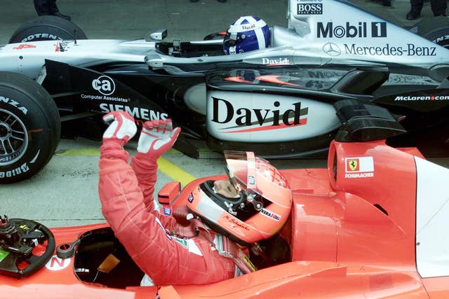 Schumacher, defending his third world title, celebrates taking pole position for the 2001 British Grand Prix.