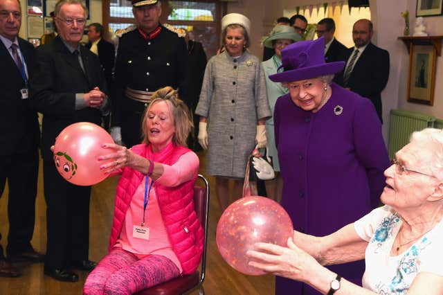 The Queen meets residents during a visit to the King George VI Day Centre (Eamonn McCormack/PA)