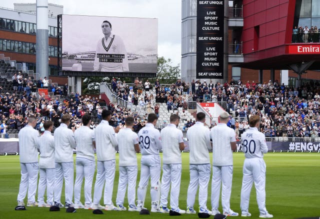 England players stand and applaud as the big screen at Old Trafford shows a tribute to former batter Graham Thorpe