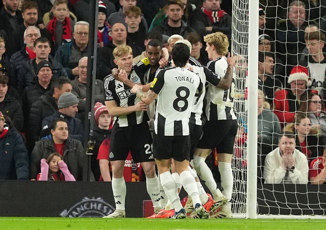 Newcastle's Alexander Isak is surrounded by team-mates after scoring the winner at Tottenham