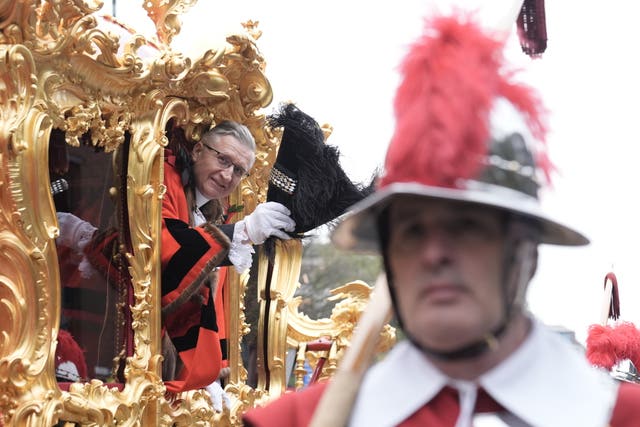 Alastair King, the 696th Lord Mayor of the City of London, waves from the state coach