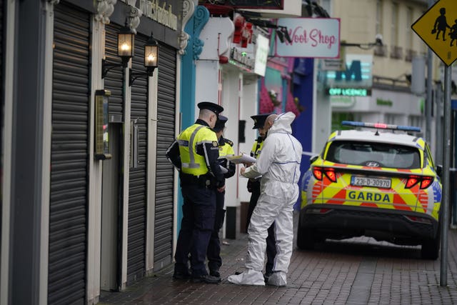 A forensic investigator speaks to Garda officers at the scene in Blanchardstown, Dublin in December 2023