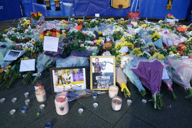 Lit candles among the flowers and messages left in tribute to Nottingham Panthers player Adam Johnson outside the Motorpoint Arena in Nottingham
