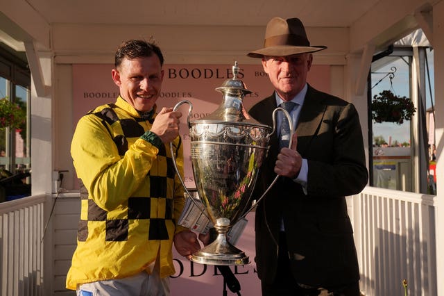 A jubilant Paul Townend and Willie Mullins with the big-race trophy 