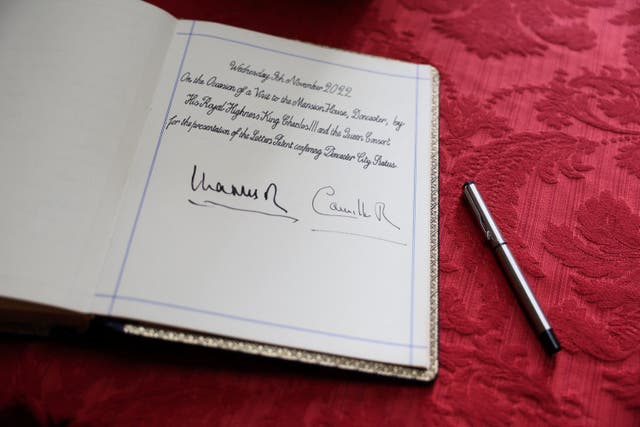 The visitors' book signed by Charles and Camilla