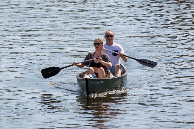 People canoe along the River Bure at Wroxham on the Norfolk Broads