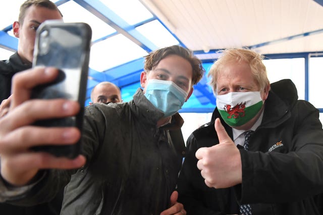Prime Minister Boris Johnson poses for a photo during a visit to Marco’s Cafe in Barry Island, Vale of Glamorgan, as part of the Welsh Conservative Party’s Senedd election campaign
