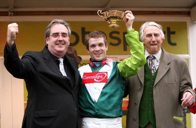 Jockey Sam Thomas celebrates with the Gold Cup trophy alongside Paul Barber (right) and Harry Findley (left)