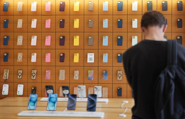 A person looking at Apple iPhone cases on display in the tech giant’s flagship Apple store in Regent Street, central London