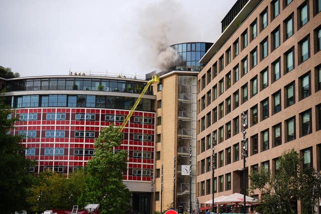 Firefighters battling a blaze at the Helios Building
