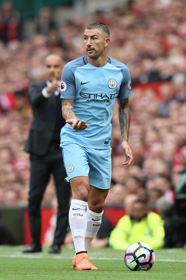 Pep Guardiola watches on with Aleksandar Kolarov in possession 