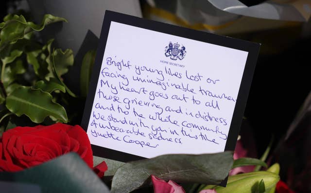 A message in a bouquet of flowers from Home Secretary Yvette Cooper near the scene in Hart Street, Southport