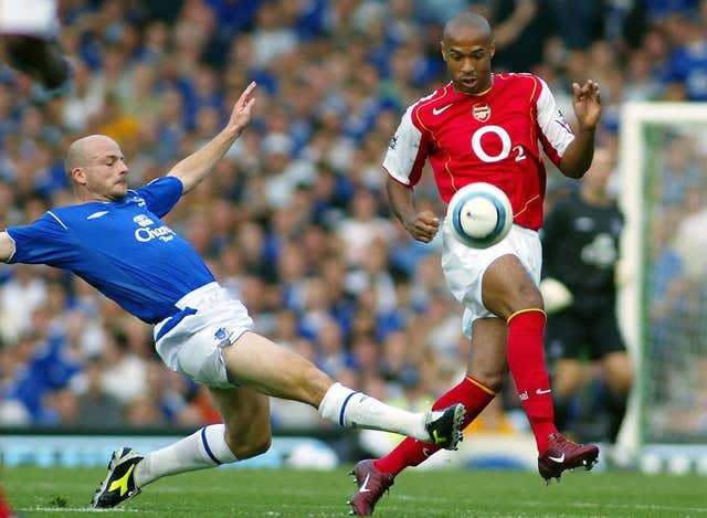 Everton’s Lee Carsley slides in to tackle Arsenal’s Thierry Henry