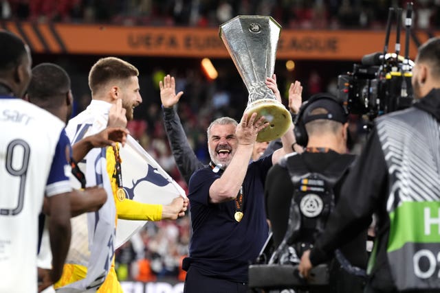Tottenham manager Ange Postecoglou (centre) celebrates with the Europa League trophy