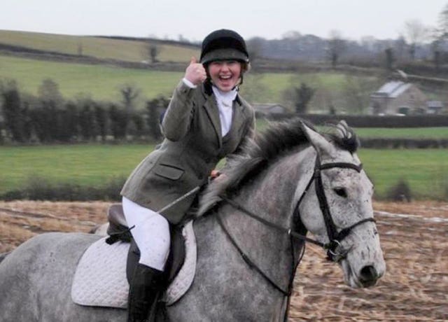 A woman riding a horse