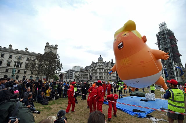 The Baby Trump Balloon takes to the sky in Parliament Square, London (David Mirzoeff/PA)