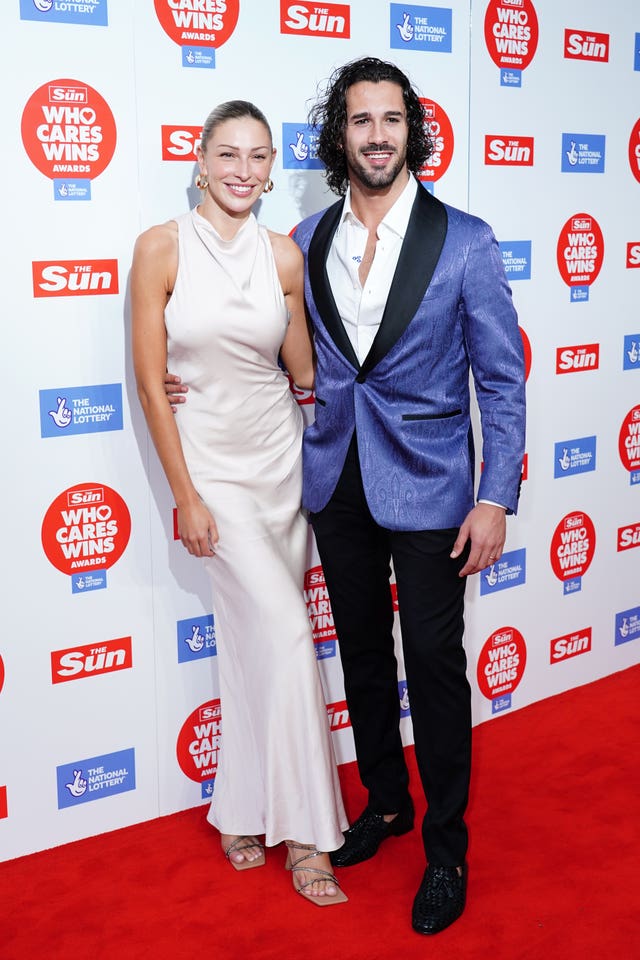 A man in a blue evening jacket and a woman in a long white dress 