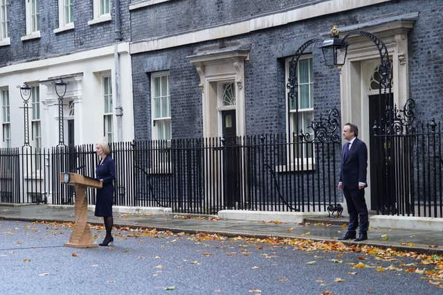 Liz Truss, with her husband Hugh O’Leary, making a statement outside 10 Downing Street