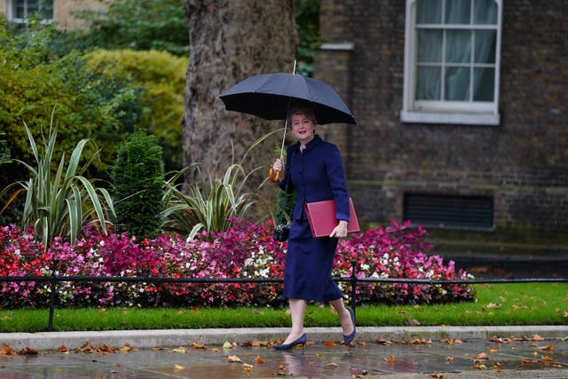 Yvette Cooper holding a black umbrella