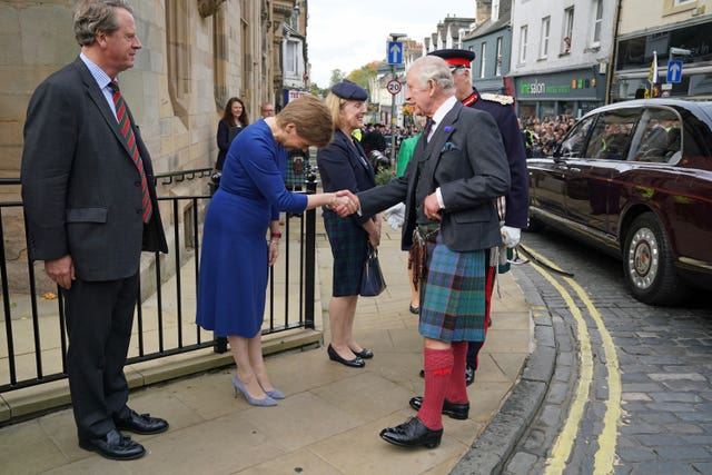 King Charles III shakes hands with First Minister Nicola Sturgeon as Scottish Secretary Alister Jack (left) looks on, as he arrives at the City Chambers in Dunfermline, Fife, to formally mark the conferral of city status on the former town