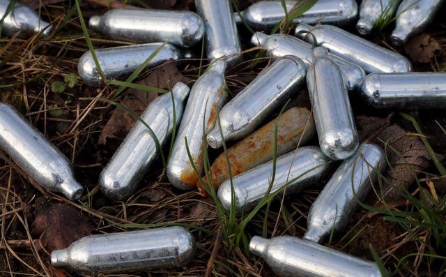 Discarded canisters of nitrous oxide