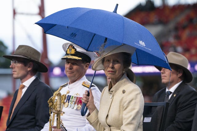 The Princess Royal uses an umbrella