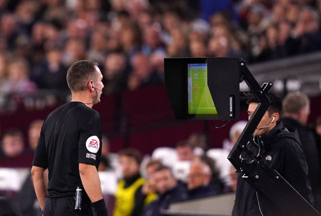 Referee David Coote consults with VAR