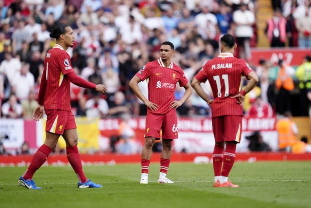 Liverpool’s Trent Alexander-Arnold (centre), Virgil van Dijk and Mohamed Salah (right) stand dejected