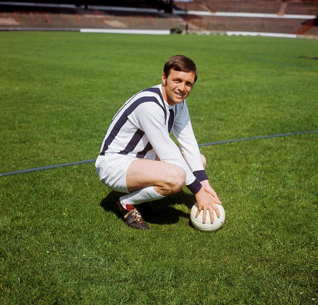 Jeff Astle squates on the pitch
