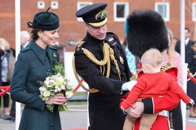 The royal couple speak to a young guest 