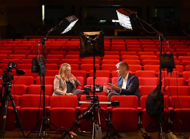 Matt Brittin speaking while seated alongside Laura Kuenssberg in a theatre