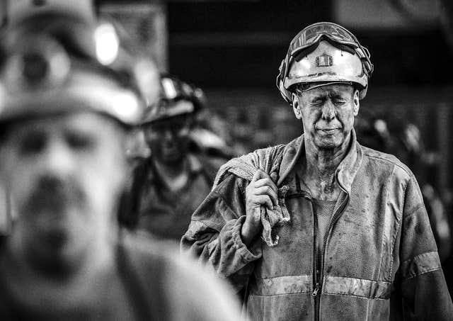 Miners come off the last shift at Kellingley Colliery on the final day of production in 2015 (John Giles/PA)