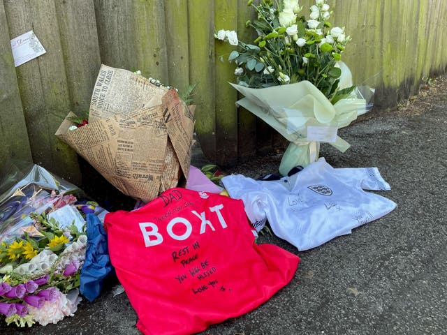 Football shirts left beside floral tributes for Ian Coates by his sons Lee and James.